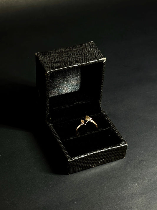 Rose Gold vermeil ring featuring two small butterflies on a dainty band on black background.