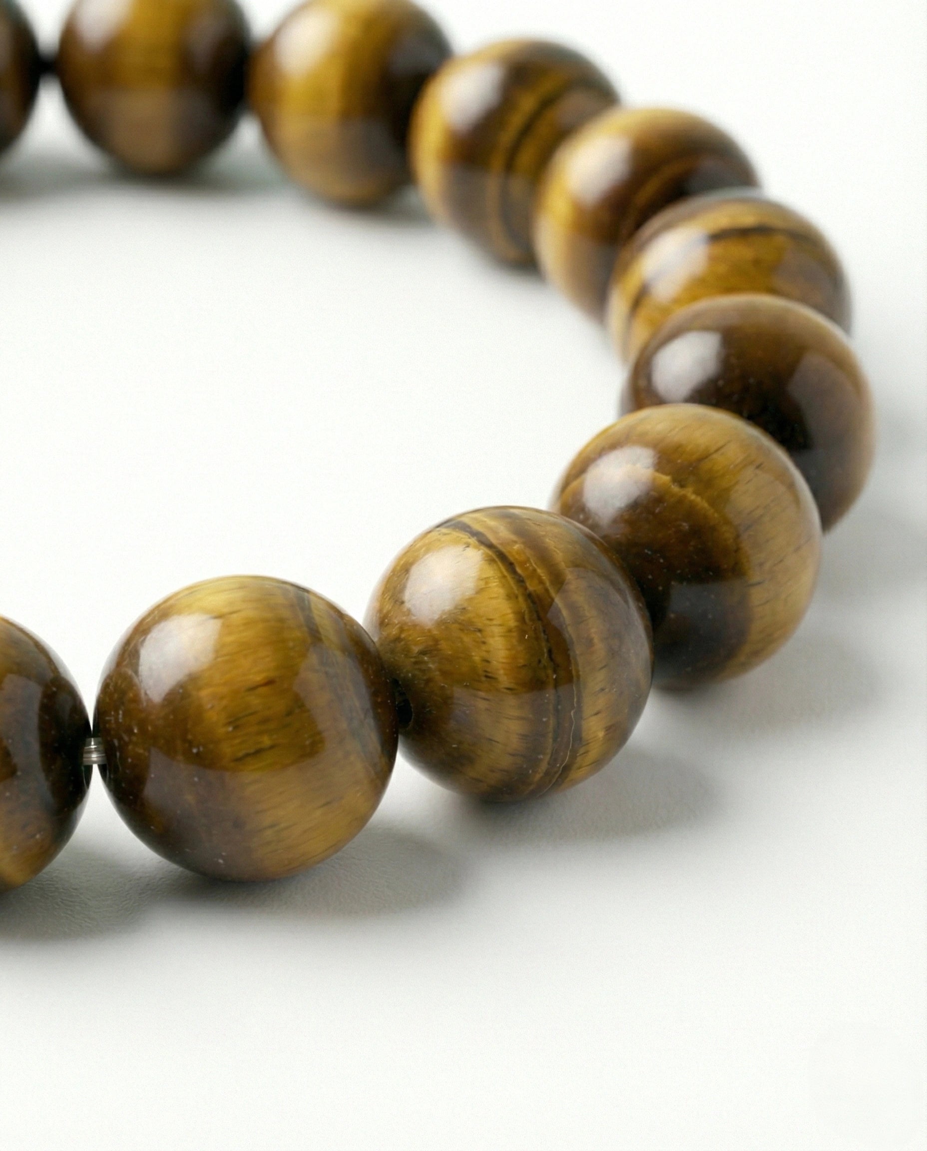 Natural Tiger Eye beaded bracelet featuring 8mm golden-brown chatoyant stones on white background.