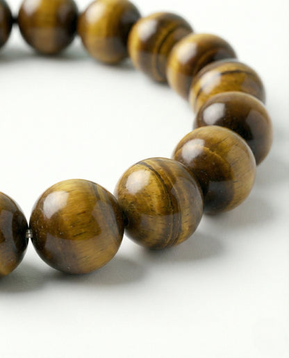 Natural Tiger Eye beaded bracelet featuring 8mm golden-brown chatoyant stones on white background.