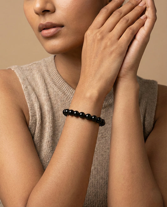 Natural Black Obsidian beaded bracelet featuring shiny 8mm black stones on white background.