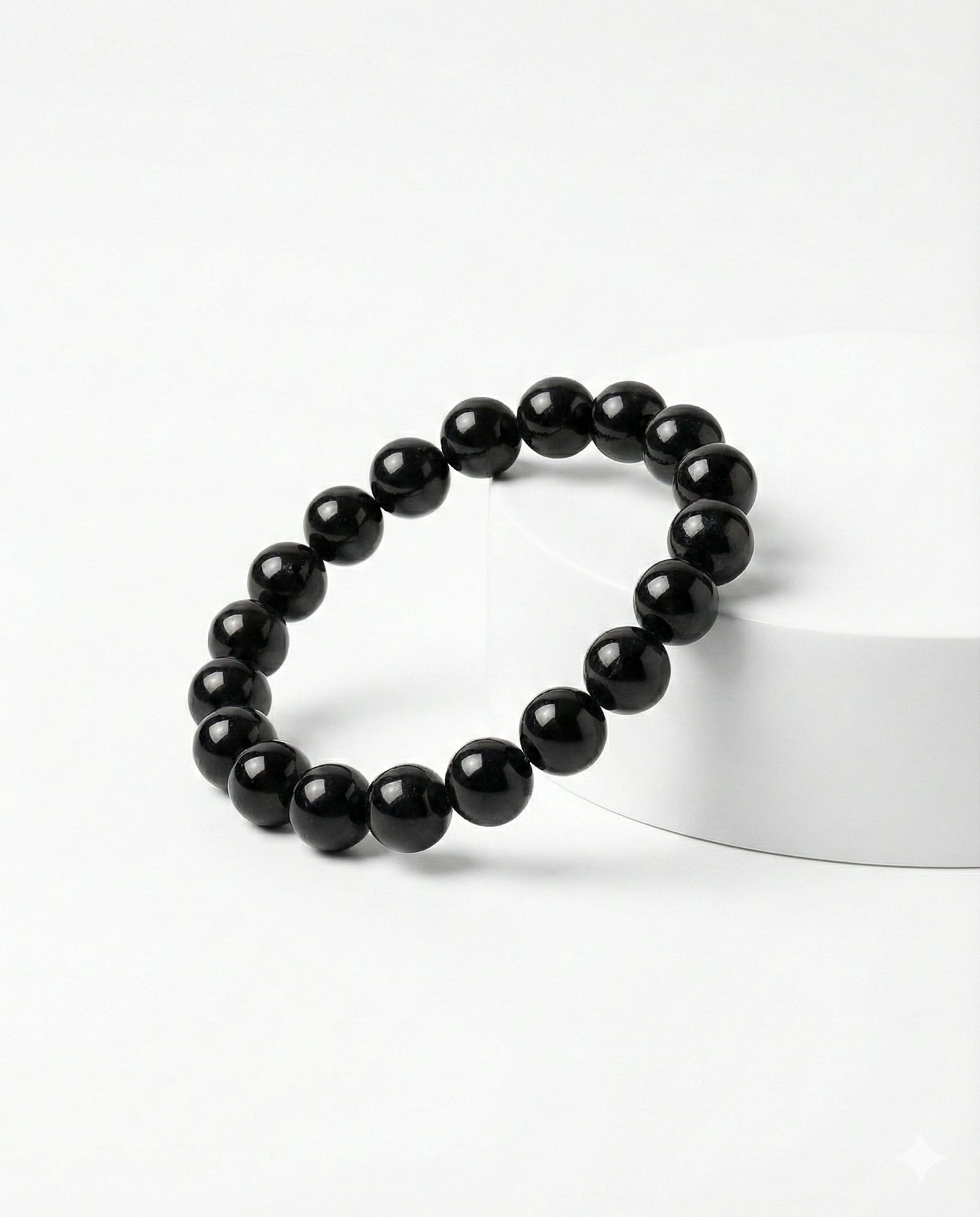 Natural Black Obsidian beaded bracelet featuring shiny 8mm black stones on white background.