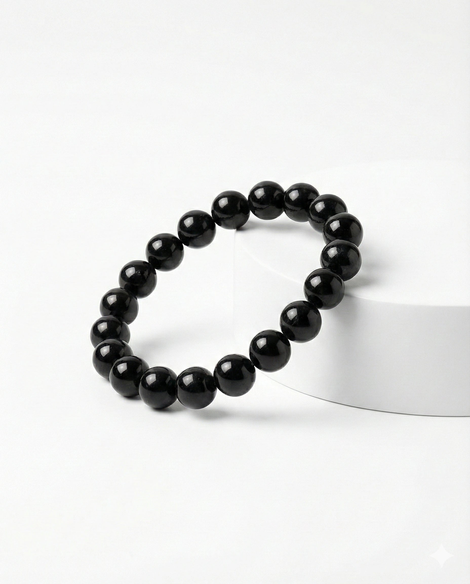 Natural Black Obsidian beaded bracelet featuring shiny 8mm black stones on white background.
