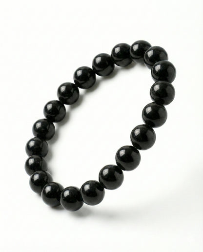Natural Black Obsidian beaded bracelet featuring shiny 8mm black stones on white background.