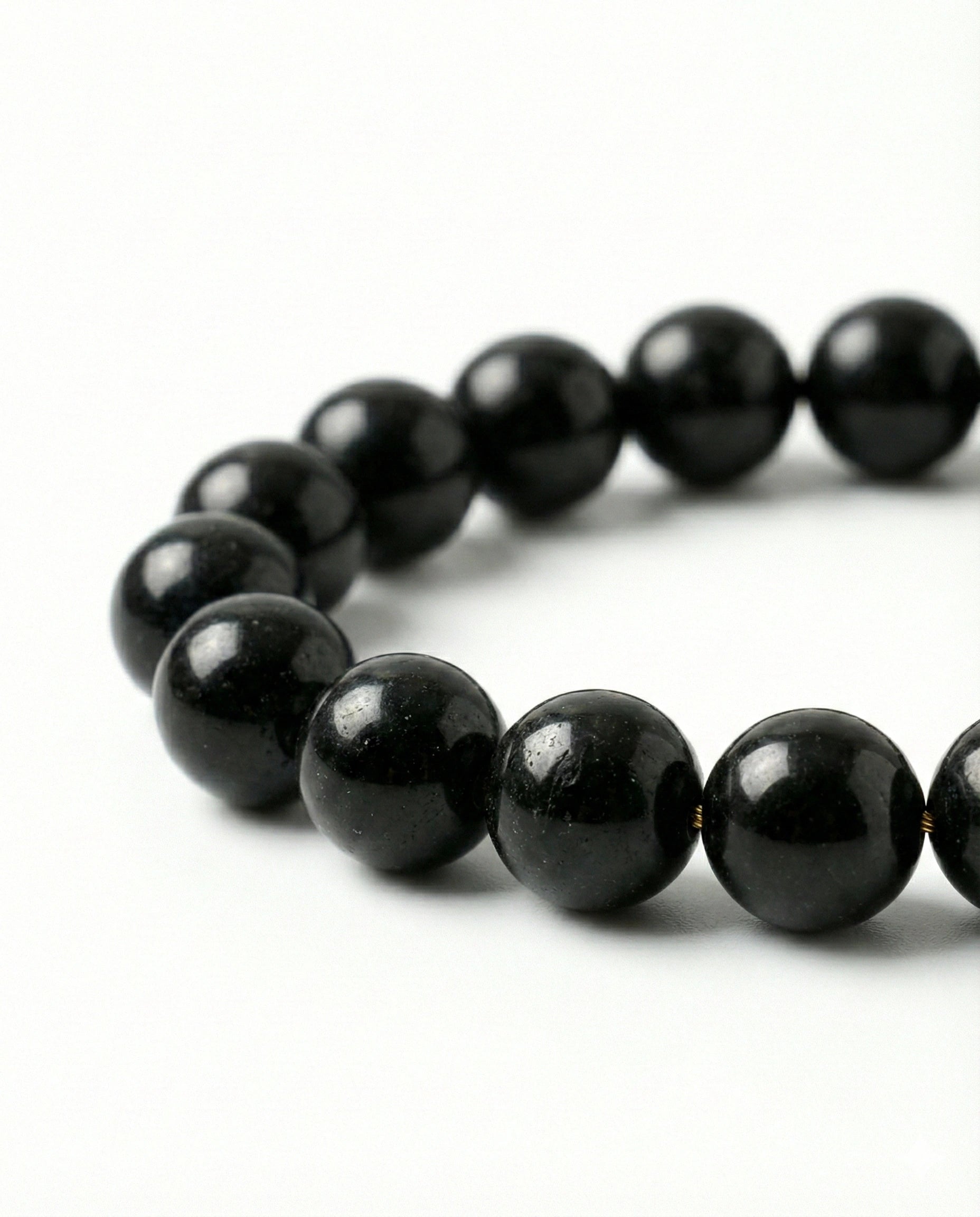 Natural Black Obsidian beaded bracelet featuring shiny 8mm black stones on white background.
