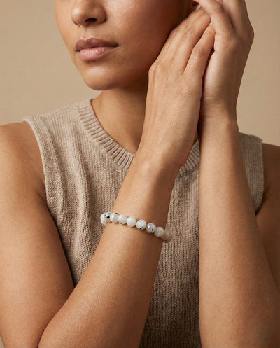 Natural Rainbow Moonstone beaded bracelet featuring 8mm white stones with black tourmaline inclusions on white background.