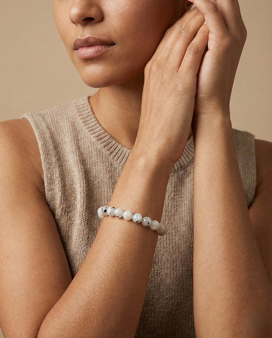 Natural Rainbow Moonstone beaded bracelet featuring 8mm white stones with black tourmaline inclusions on white background.