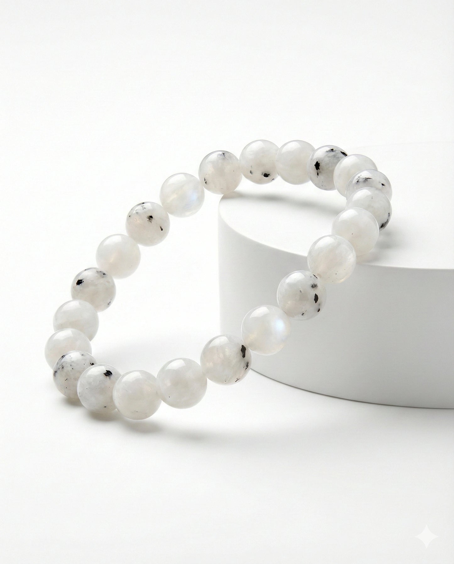 Natural Rainbow Moonstone beaded bracelet featuring 8mm white stones with black tourmaline inclusions on white background.