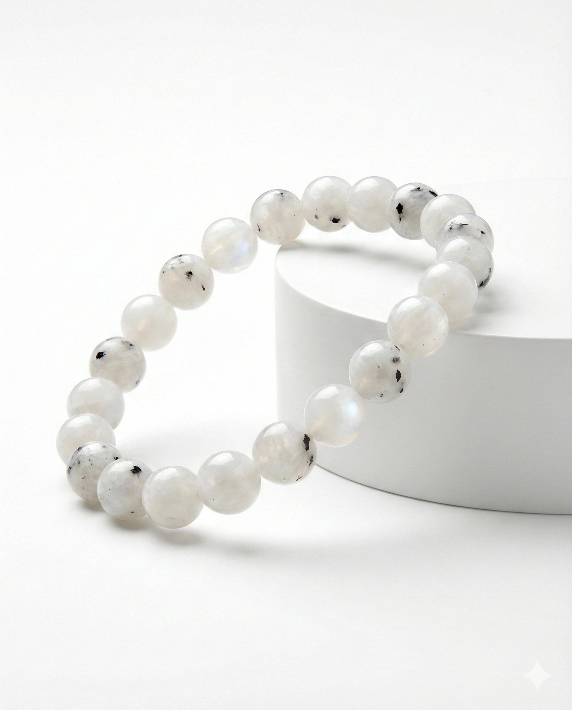 Natural Rainbow Moonstone beaded bracelet featuring 8mm white stones with black tourmaline inclusions on white background.