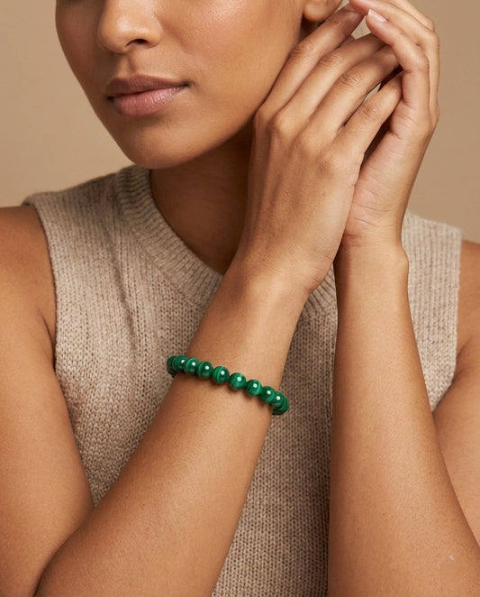 Natural Malachite beaded bracelet featuring 8mm green banded stones on white background.