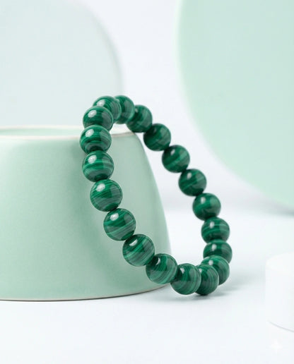 Natural Malachite beaded bracelet featuring 8mm green banded stones on white background.