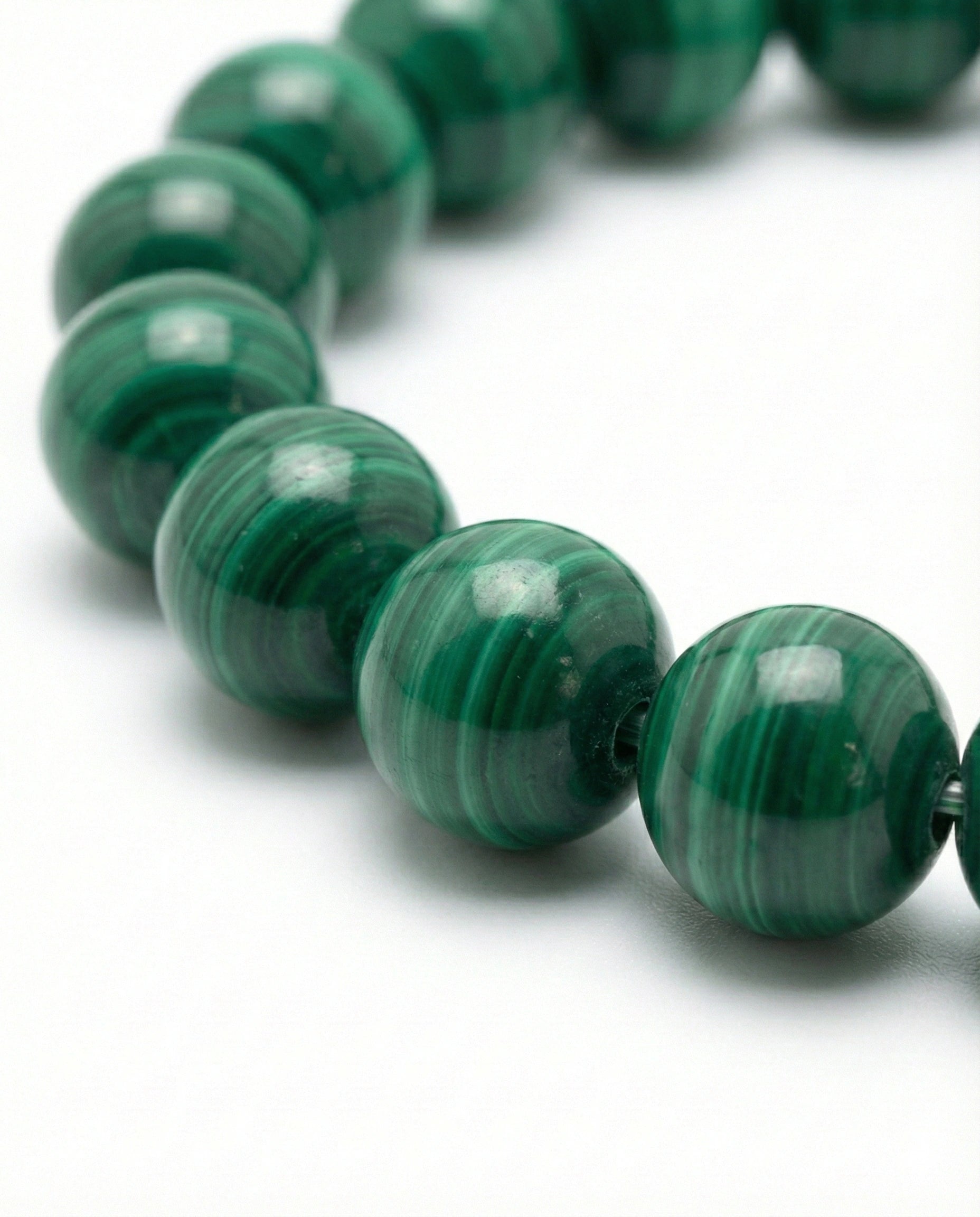 Natural Malachite beaded bracelet featuring 8mm green banded stones on white background.