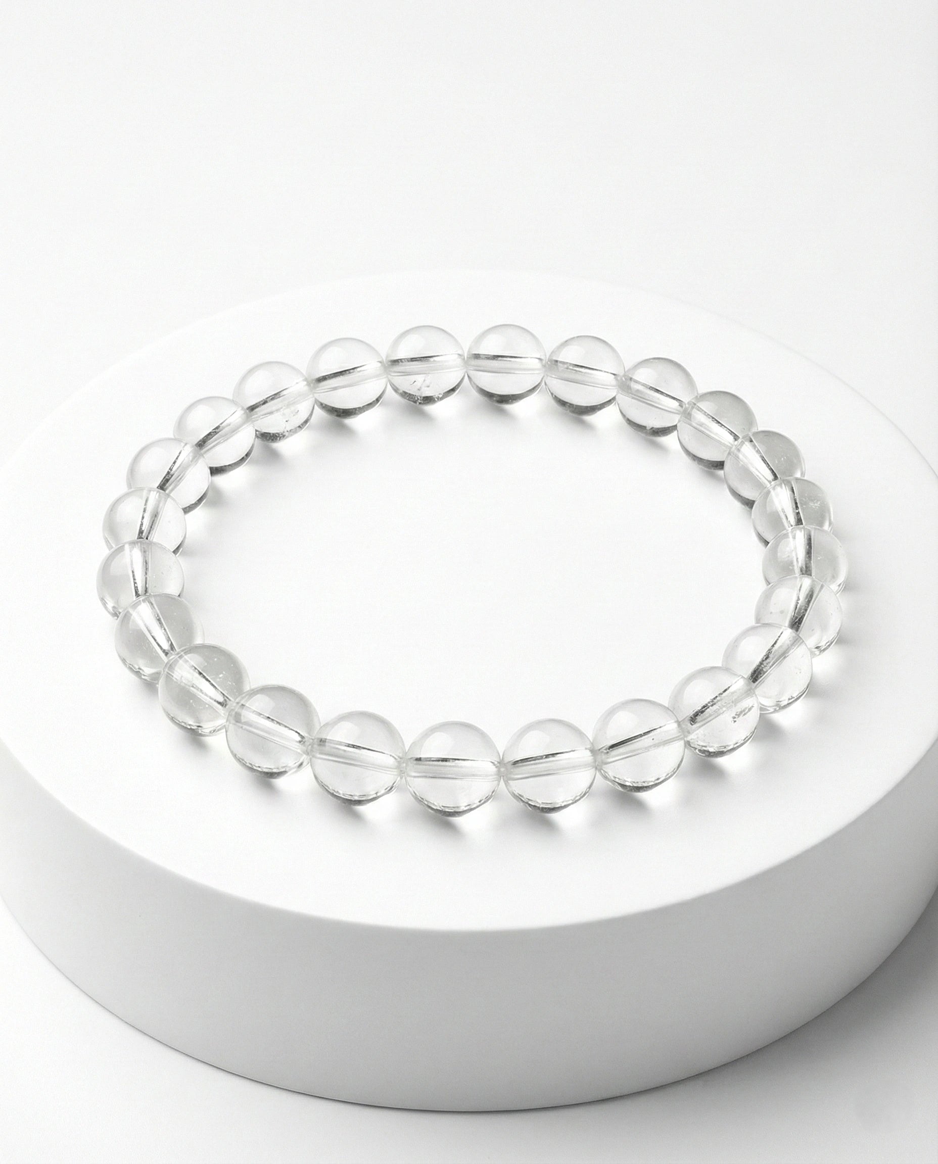 Natural Clear Quartz beaded bracelet with transparent round gemstones on black background.