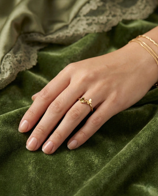 Rose Gold vermeil ring featuring two small butterflies on a dainty band on black background.
