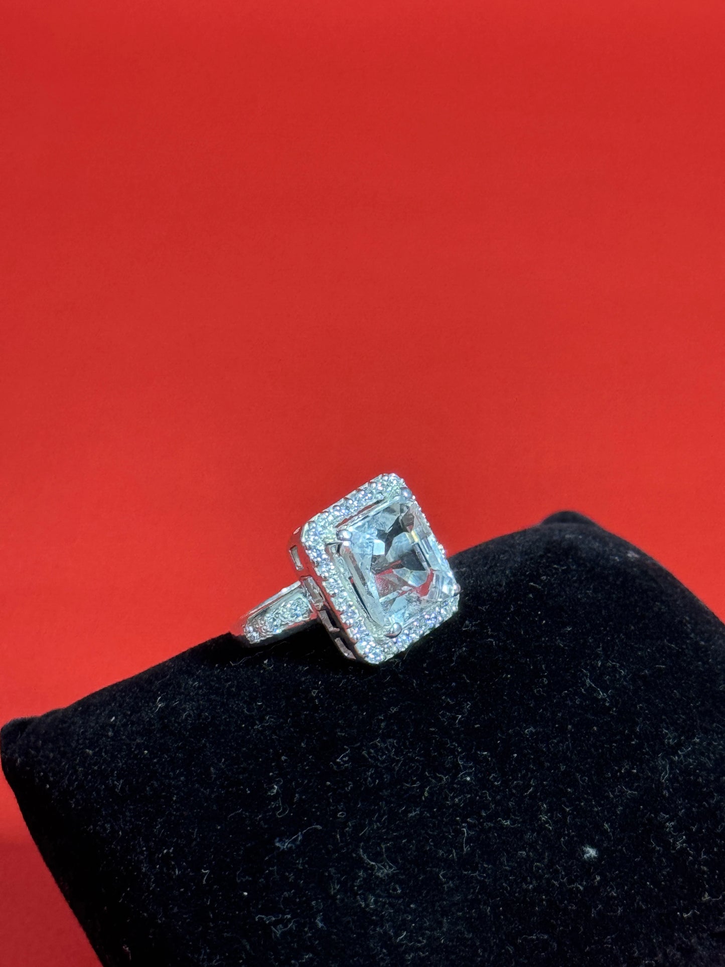 Large rectangular Clear Quartz gemstone ring with halo setting in 925 sterling silver on black background