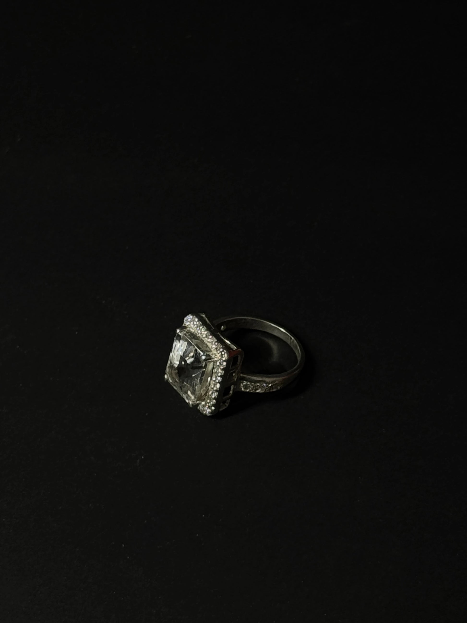 Large rectangular Clear Quartz gemstone ring with halo setting in 925 sterling silver on black background